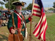 Gentleman dressed as patriot solider with American flag