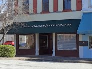 Two Story Historic Building- Cream with Red Trim and Green Awning that Says Edward Jones Investments