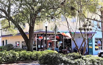 Outdoor photo of Tipsy McSway's Bar with  outdoor seating and trees and shrubs in the foreground